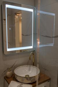 a bathroom with a sink and a mirror at AGORA luxury BOUTIQUE HOTEL in Loutraki