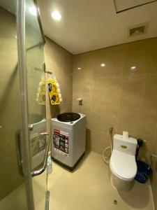 a small bathroom with a toilet and a shower at Vinhomes Times City 1BR in Hanoi