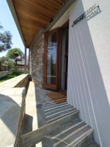 a front door of a house with a wooden porch at VIGLA IERISSOS in Ierissos
