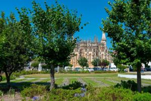 a large building with trees in front of it at The Modern 1385 Apartment in Batalha