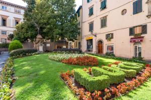 a garden with a hedge in the shape of the word love at Piazza Napoleone Lovely Central Apartment in Lucca