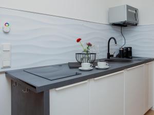 a kitchen counter with a sink and a flower on it at Zwick Apartments in Kammerstein