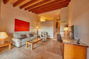 a living room with a couch and a table at Pula Suites Boutique Resort in Son Servera