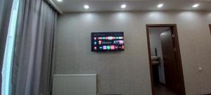 a television hanging on a wall in a room at Apartment in Tbilisi near Didube metro station in Tbilisi City