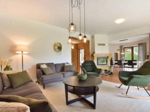 a living room with a couch and chairs and a table at To Tu Dom in Brenna