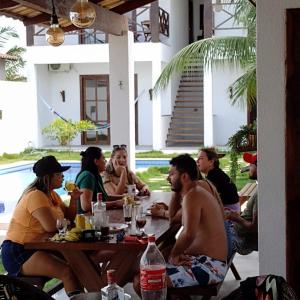 a group of people sitting around a table at Casa Vila Prea Jericoacoara é logo ali in Prea