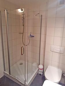 a bathroom with a shower and a toilet at Yachthafenresidenz-Wohnung-9307-899 in Kühlungsborn