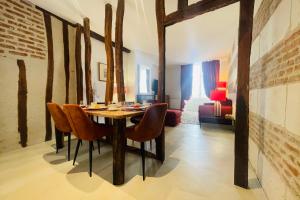 a dining room with a table and chairs at Splendid apartment at the foot of the castle of Amboise - View of the Loir in Amboise