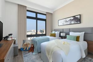 เตียงในห้องที่ Le Mirage Downtown
