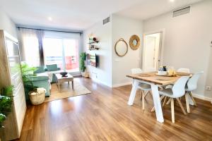 Playa Granada Apartamentos Moriscos II في موتريل: غرفة طعام وغرفة معيشة مع طاولة وكراسي