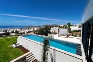 a swimming pool on the side of a house at Vistaport B - Luxury Villa in Bodrum City