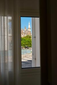 a view of a city from a window at The Modern 1385 Apartment in Batalha