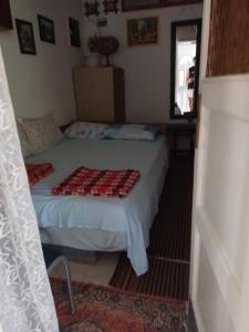 a small bedroom with a bed and a window at APARTMANI NATALIJA in Bar