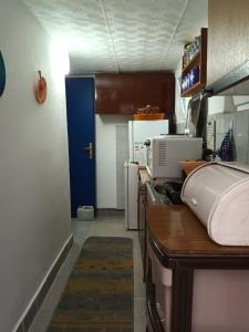 a kitchen with a sink and a blue door at APARTMANI NATALIJA in Bar