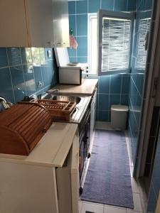 a kitchen with a sink and a stove top oven at APARTMANI NATALIJA in Bar