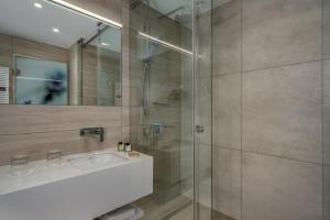 a bathroom with a sink and a shower at Ensana Thermal Margaret Island in Budapest
