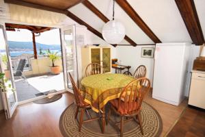 a kitchen and dining room with a table and chairs at Apartments with a parking space Kornic, Krk - 416 in Kornić