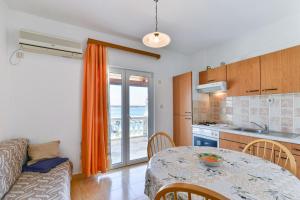 a kitchen and a dining room with a table and a kitchen and a tableablish at Apartment Tkon 336b in Tkon
