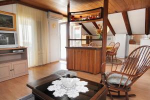 a living room with a chair and a table at Apartment Kornic 416b in Kornić