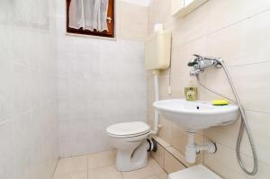 a bathroom with a toilet and a sink at Apartments and rooms by the sea Zuljana, Peljesac - 256 in Žuljana