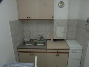 a small kitchen with a sink and a counter at Secluded fisherman's cottage Krknata, Dugi otok - 399 in Žman