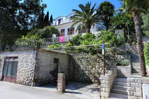 a house with a stone wall and stairs in front at Apartments and rooms by the sea Trpanj, Peljesac - 258 in Trpanj