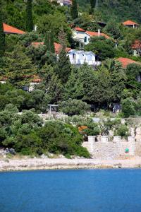 a view of a body of water with trees and houses at Apartments and rooms by the sea Trpanj, Peljesac - 258 in Trpanj