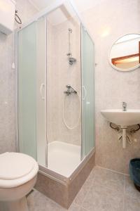 a bathroom with a shower and a toilet and a sink at Apartments and rooms by the sea Trpanj, Peljesac - 258 in Trpanj