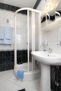 a white bathroom with a shower and a sink at Family friendly apartments with a swimming pool Kraj, Pasman - 334 in Kraj