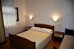 a bedroom with a bed and two lights on the wall at Apartments by the sea Luka Dubrava, Peljesac - 284 in Janjina