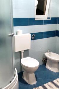 a bathroom with a white toilet and a sink at Apartments by the sea Nerezine, Losinj - 330 in Nerezine