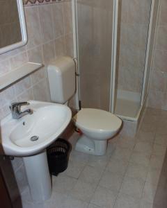 a bathroom with a toilet and a sink and a shower at Apartments by the sea Podgora, Makarska - 316 in Podgora