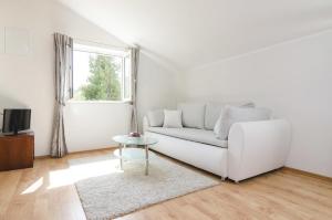 a white living room with a white couch and a window at Rooms with a swimming pool Cove Saplunara, Mljet - 401 in Maranovići