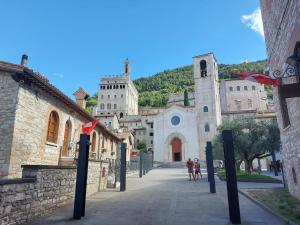 a group of people walking down a street at Residenza Via Dante in Gubbio