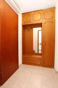 a room with wooden doors and a mirror at Triple Room Trpanj 258a in Trpanj +14 photos
