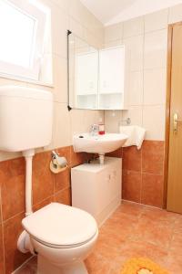 a bathroom with a toilet and a sink at Studio Zuljana 254a in Žuljana