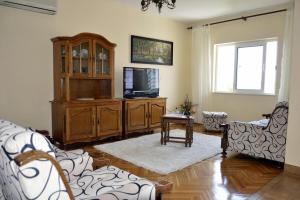 a living room with a entertainment center and a tv at Apartments by the sea Orebic, Peljesac - 269 in Orebić