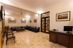 a living room with a couch and a tv at Hanuwant Niwas Jodhpur in Jodhpur