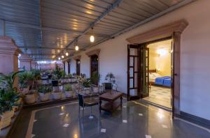 a room with a table and a bunch of plants at Hanuwant Niwas Jodhpur in Jodhpur
