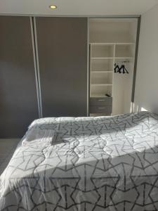 1 dormitorio con cama con edredón en MODERNA CASA EN USHUAIA en Ushuaia