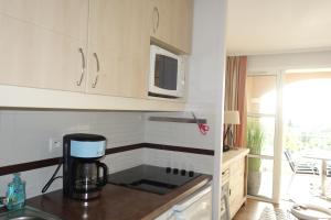 a kitchen with a coffee maker on a counter at Village Cap Estérel Agay St Raphaël vue mer et piscine in Agay - Saint Raphael
