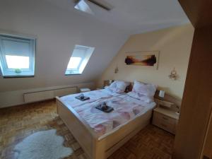 a bedroom with a large bed with white sheets and pillows at Apartment Linss in Gebesee