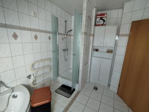 a bathroom with a shower and a sink and a tub at Apartment Linss in Gebesee