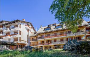 a large white building with a lot of windows at Nice Apartment Santo Stefano in Santo Stefano dʼAveto