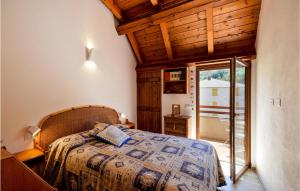 a bedroom with a bed with a wooden ceiling at Nice Apartment Santo Stefano in Santo Stefano dʼAveto