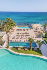 an aerial view of a resort with a pool and the ocean at Royal Azur Thalassa in Hammamet