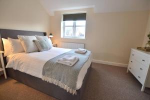 a bedroom with a bed with towels on it at Park View in Hathern
