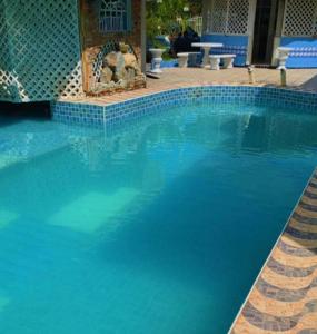 a large swimming pool with blue water at Relaxing 2 bedroom property for up to 4 person in Georgetown