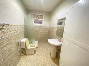 a bathroom with a toilet and a sink at Private Cottage in Sharjah