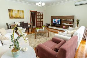 a living room with a couch and a tv at Kaplan Cosy Flat - All air conditioned & Heated 3 Bedrooms in the City in Istanbul